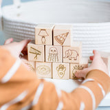 Child stacking wooden abc blocks